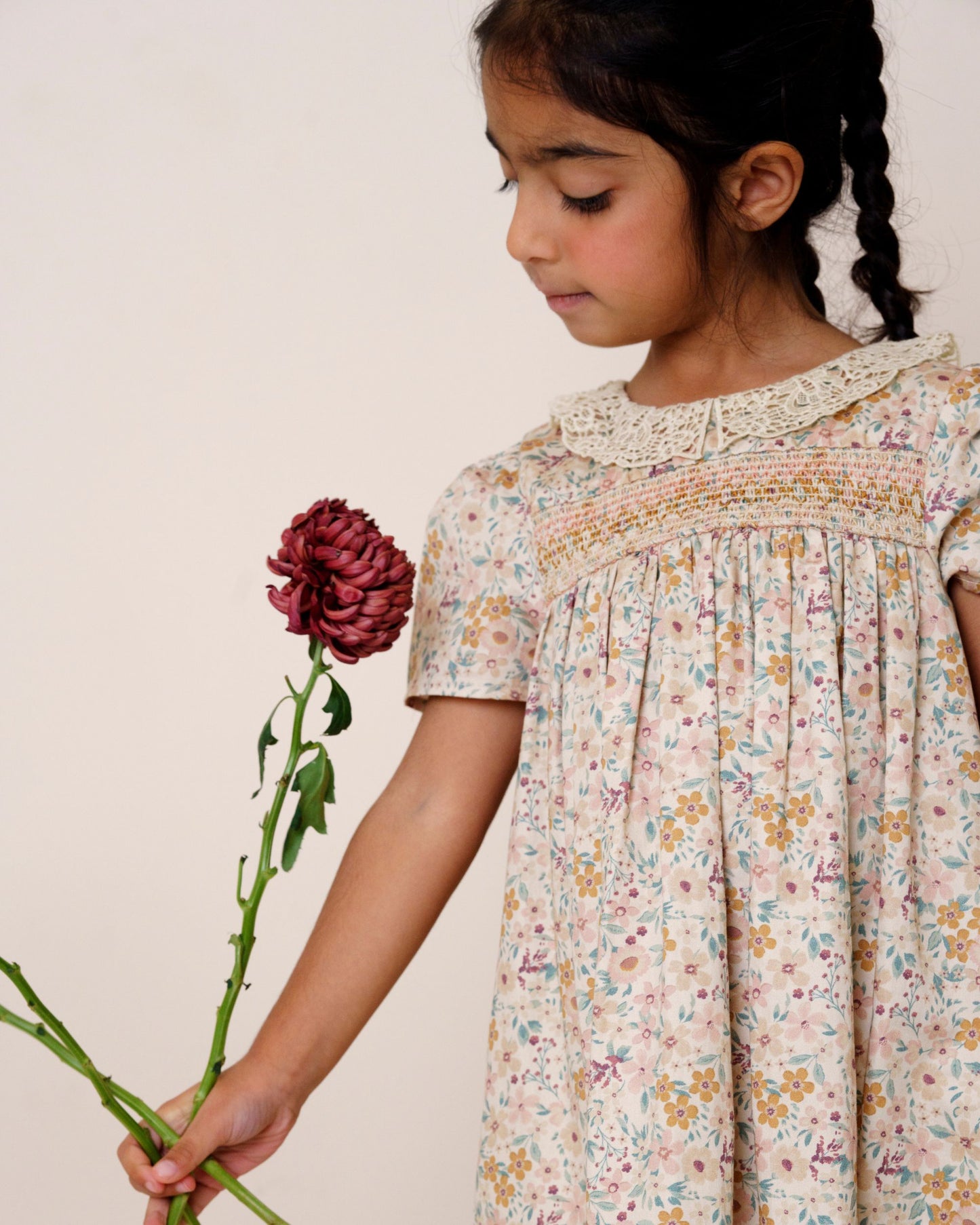 Early Sunday, Erika Dress in Floral print, made from Printed Cotton Satin fabric, featuring Flowy A-line silhouette allows ease of movement and day-long comfort, shown in a close up shot of model wearing it