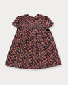 Early Sunday, Erika Dress in Plum, made from Printed Cotton Satin fabric, featuring a floral print with peter pan collar, shown in a back flat-lay view