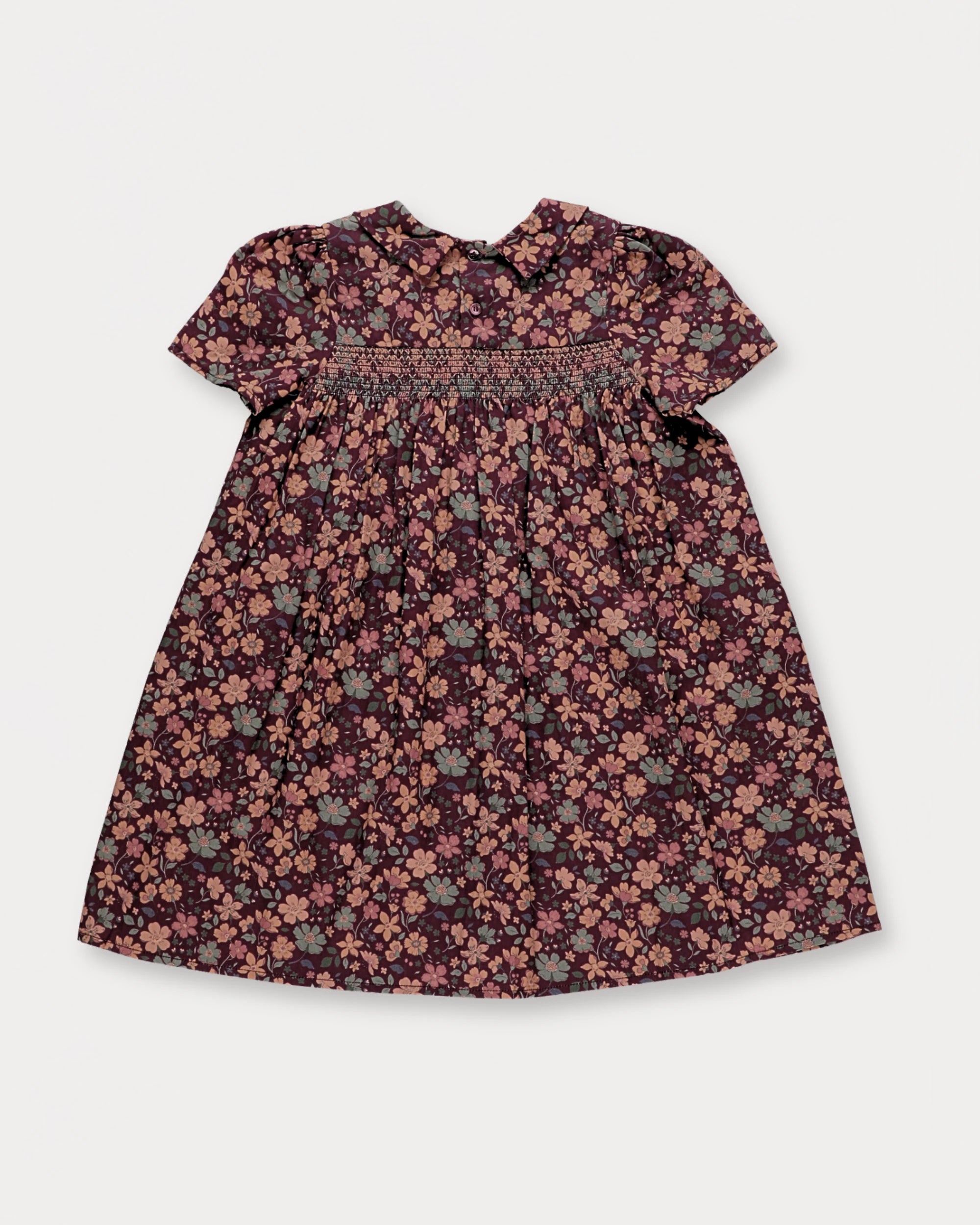 Early Sunday, Erika Dress in Plum, made from Printed Cotton Satin fabric, featuring a floral print with peter pan collar, shown in a back flat-lay view
