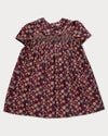 Early Sunday, Erika Dress in Plum, made from Printed Cotton Satin fabric, featuring a floral print with peter pan collar, shown in a front flat-lay view