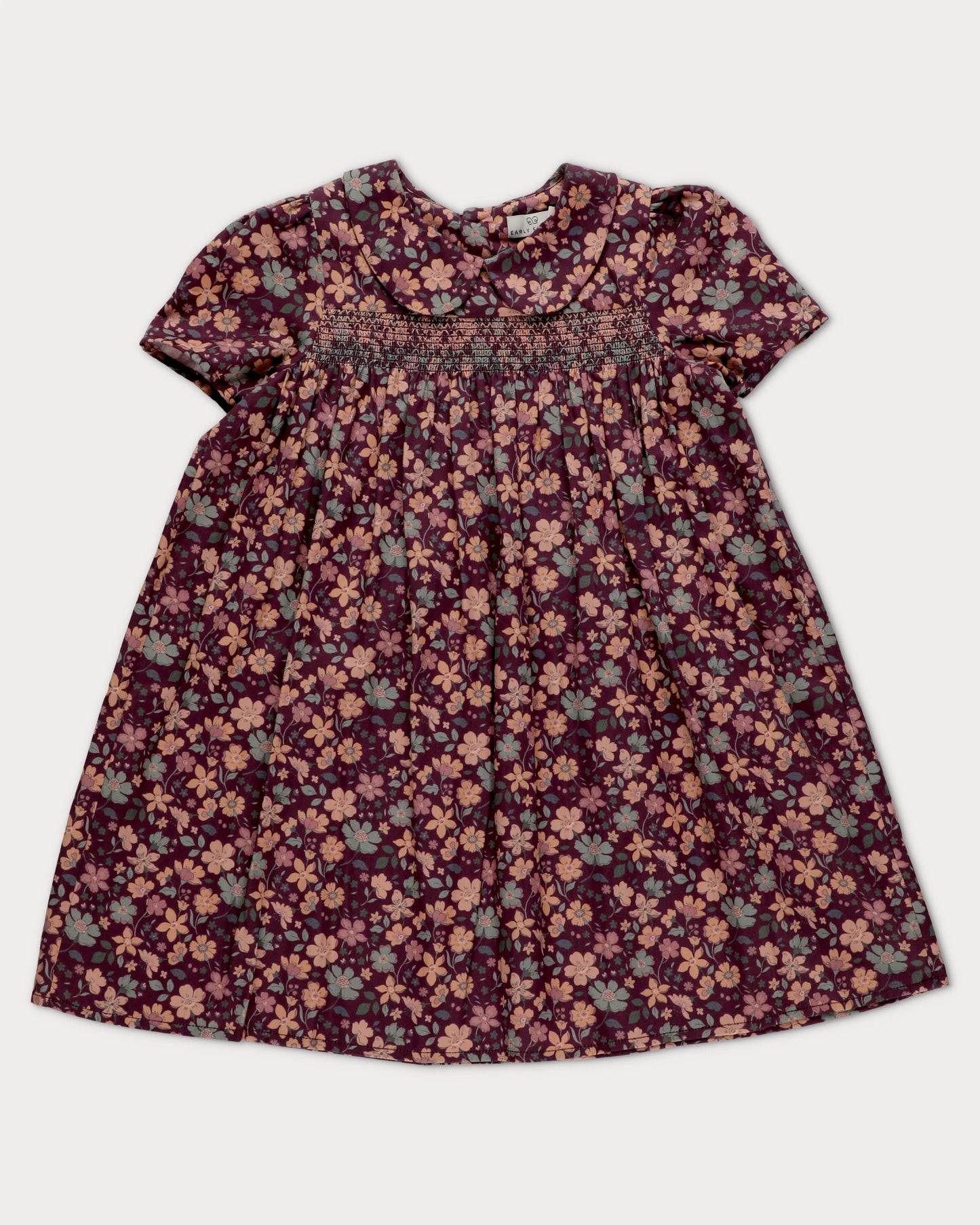 Early Sunday, Erika Dress in Plum, made from Printed Cotton Satin fabric, featuring a floral print with peter pan collar, shown in a front flat-lay view