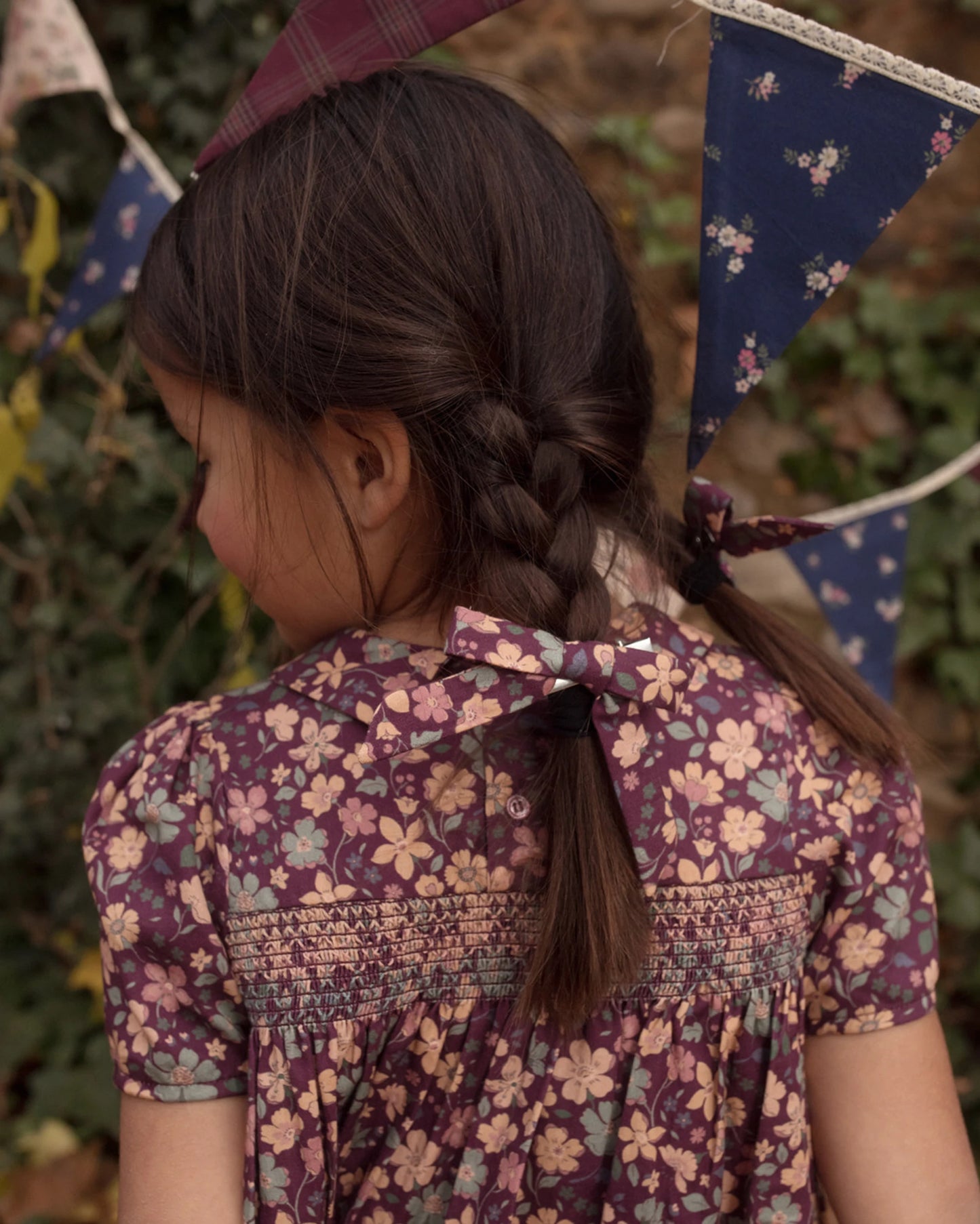 Early Sunday, Erika Dress in Plum, made from Printed Cotton Satin fabric, featuring a floral print with peter pan collar, shown in a close up shot of model wearing it