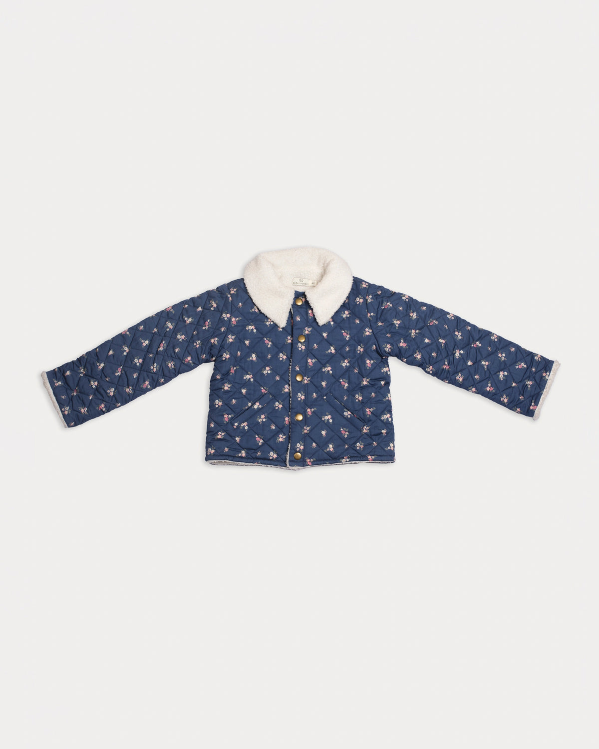 Early Sunday, Esmée Jacket in Ditsy Bouquet Navy, made from Printed Cotton Satin fabric, featuring a quilted layer with floral detailing, shown in a front flat-lay view