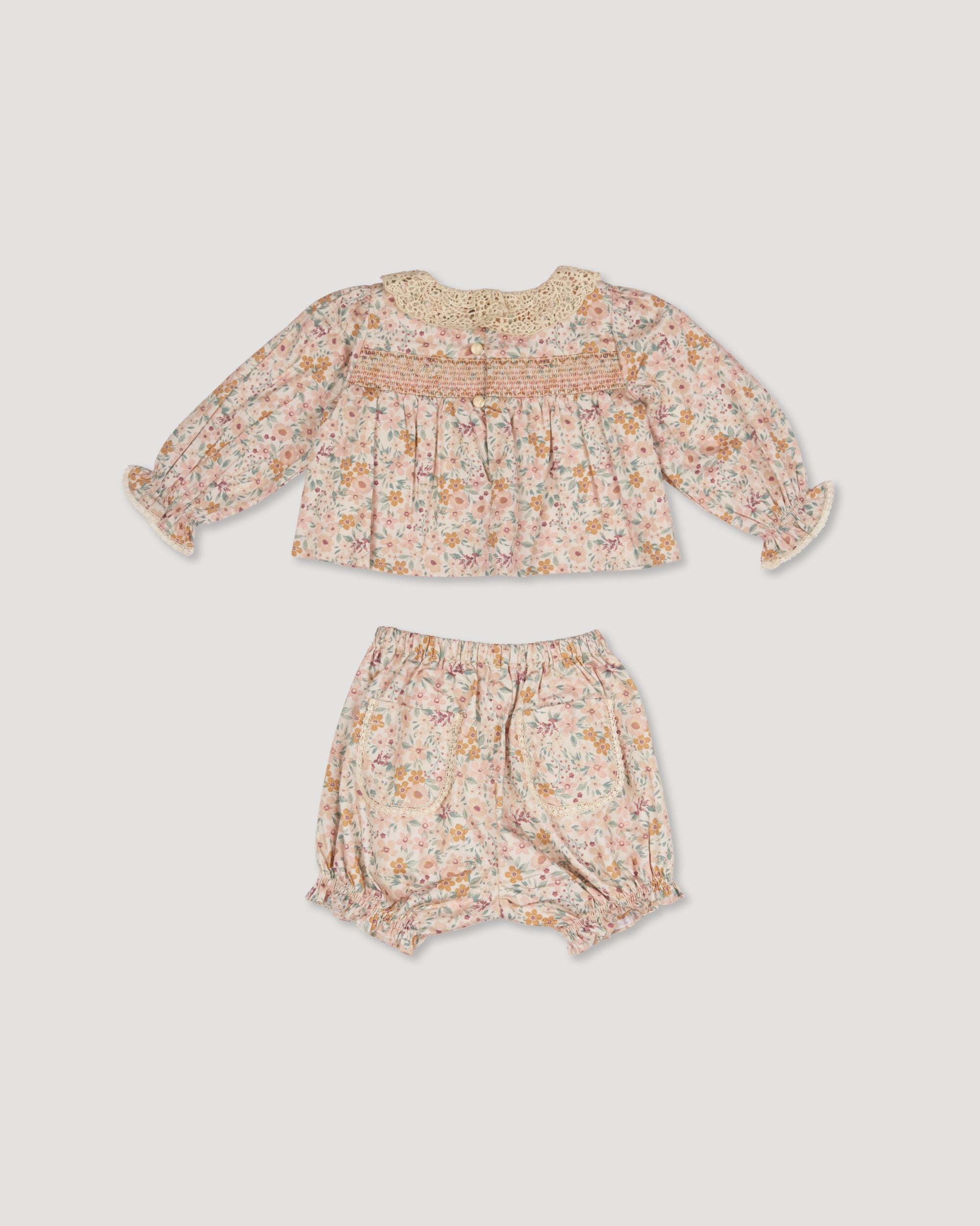 Early Sunday, Essie & Pippy Baby Set in Floral print, made from Printed 60s Cotton Satin fabric, featuring smocked sleeves with laced neckline & matching bloomers, shown in a back flat-lay view