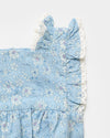 Early Sunday, Eva Baby Romper in Tonal Floral Blue color, made from 100% Cotton Swiss Dobby Tiny Dots fabric, featuring a sleeveless design with lace border, shown in a closeup flat-lay view