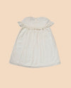 Early Sunday, Faustine Dress in Ivory color, made from 100% cotton swiss dobby tiny dots fabric, featuring Soft gathers with delicate ruffle accents, shown in a back flat-lay view
