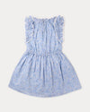 Early Sunday, Florence Dress in Tonal Floral Blue color, made from printed cotton tiny swiss dobby fabric, featuring Ruffle detailing on the yoke and sleeves, lace accents, gathered waist with tassel tie, shown in a back flat-lay view