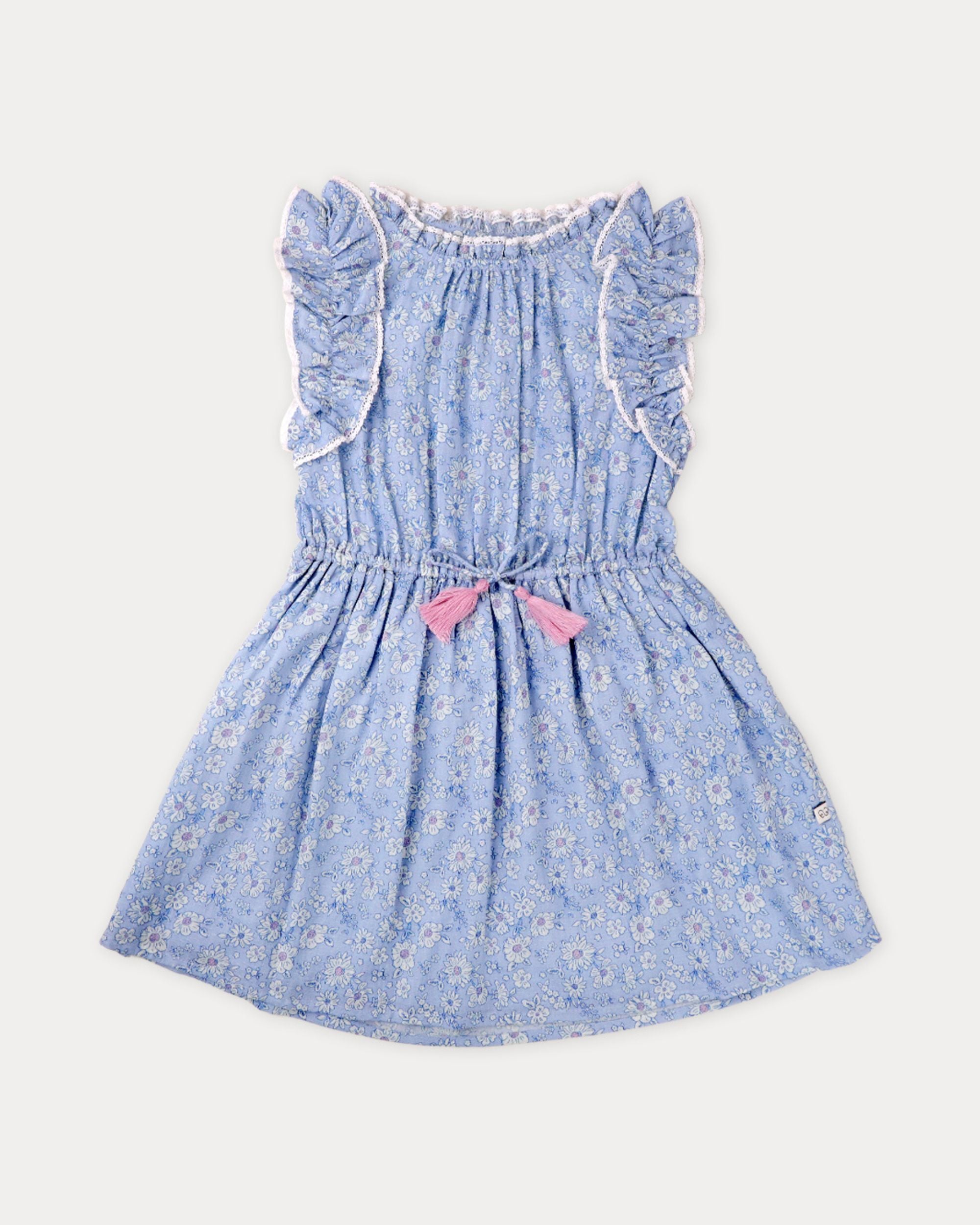 Early Sunday, Florence Dress in Tonal Floral Blue color, made from printed cotton tiny swiss dobby fabric, featuring Ruffle detailing on the yoke and sleeves, lace accents, gathered waist with tassel tie, shown in a front flat-lay view