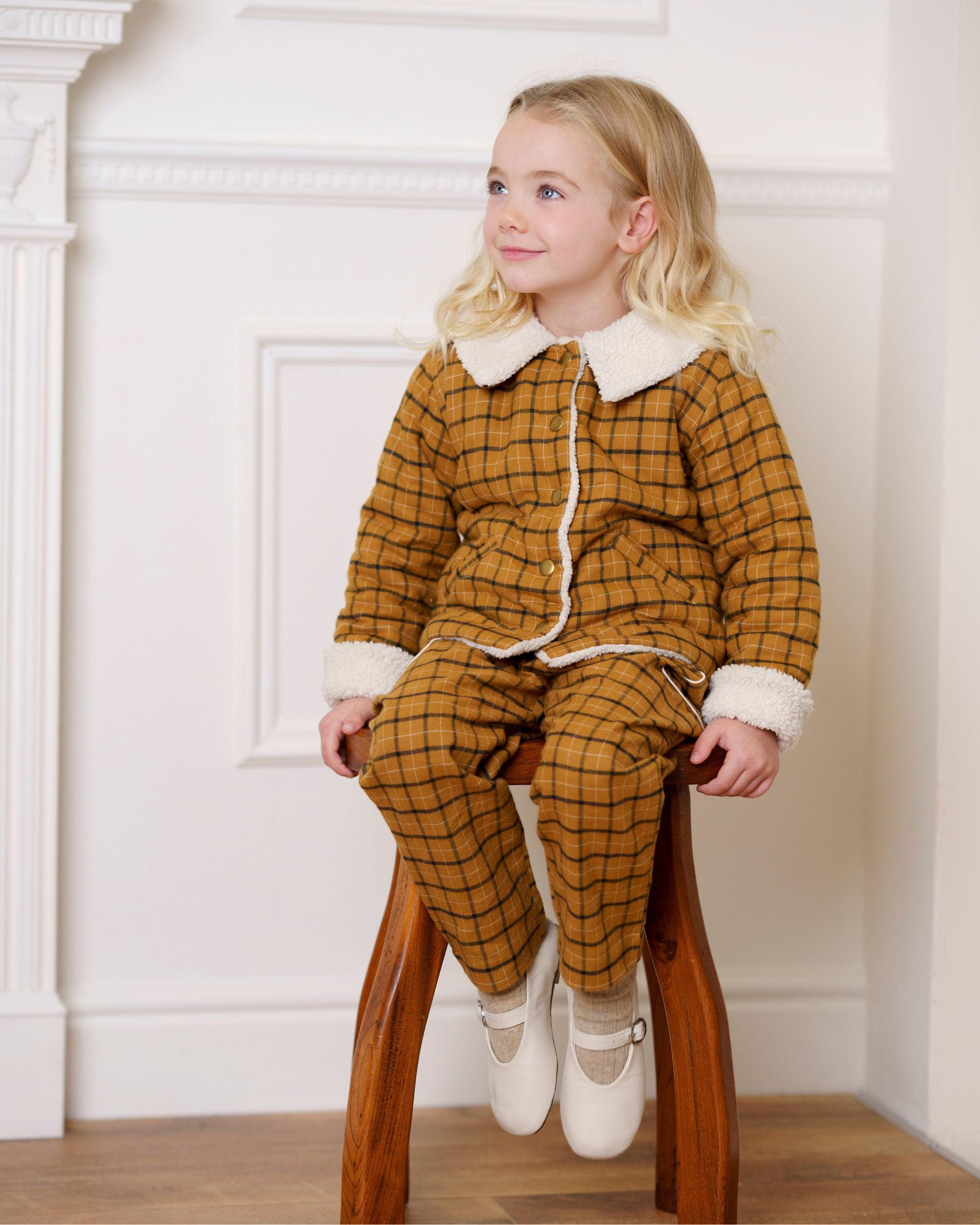 Early Sunday, Franka Jacket in Almond Checks, made from Cotton Yarn Dyed Brushed Checks fabric, featuring Cozy, softly structured jacket with a plush sherpa lining and gentle detailing for warmth without bulk, shown in a front view of a model wearing it in a studio setting
