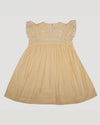 Early Sunday, Georgia Dress in Vanilla color, made from Cotton Dobby Swiss Dots fabric, featuring flutter sleeves, pintuck detailing, and a flowy, gathered silhouette, shown in a front flat-lay view