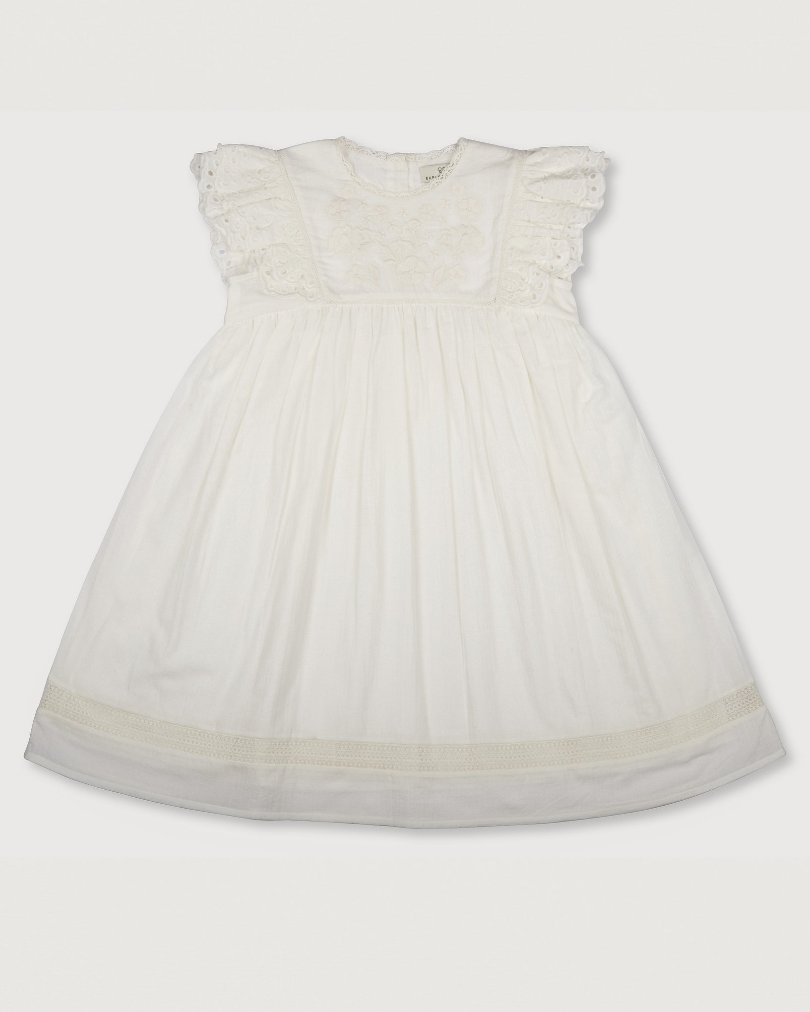 Early Sunday, Georgia Dress in Ivory print, made from Cotton Tiny Swiss Dots fabric, featuring Flutter sleeves, pintuck detailing, and a flowy, gathered silhouette, shown in a front flat-lay view