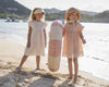 Early Sunday, Georgia Dress in Ivory color, made from Cotton Tiny Swiss Dots fabric, featuring Flutter sleeves, pintuck detailing, and a flowy, gathered silhouette, shown in a front view of models playing outdoors