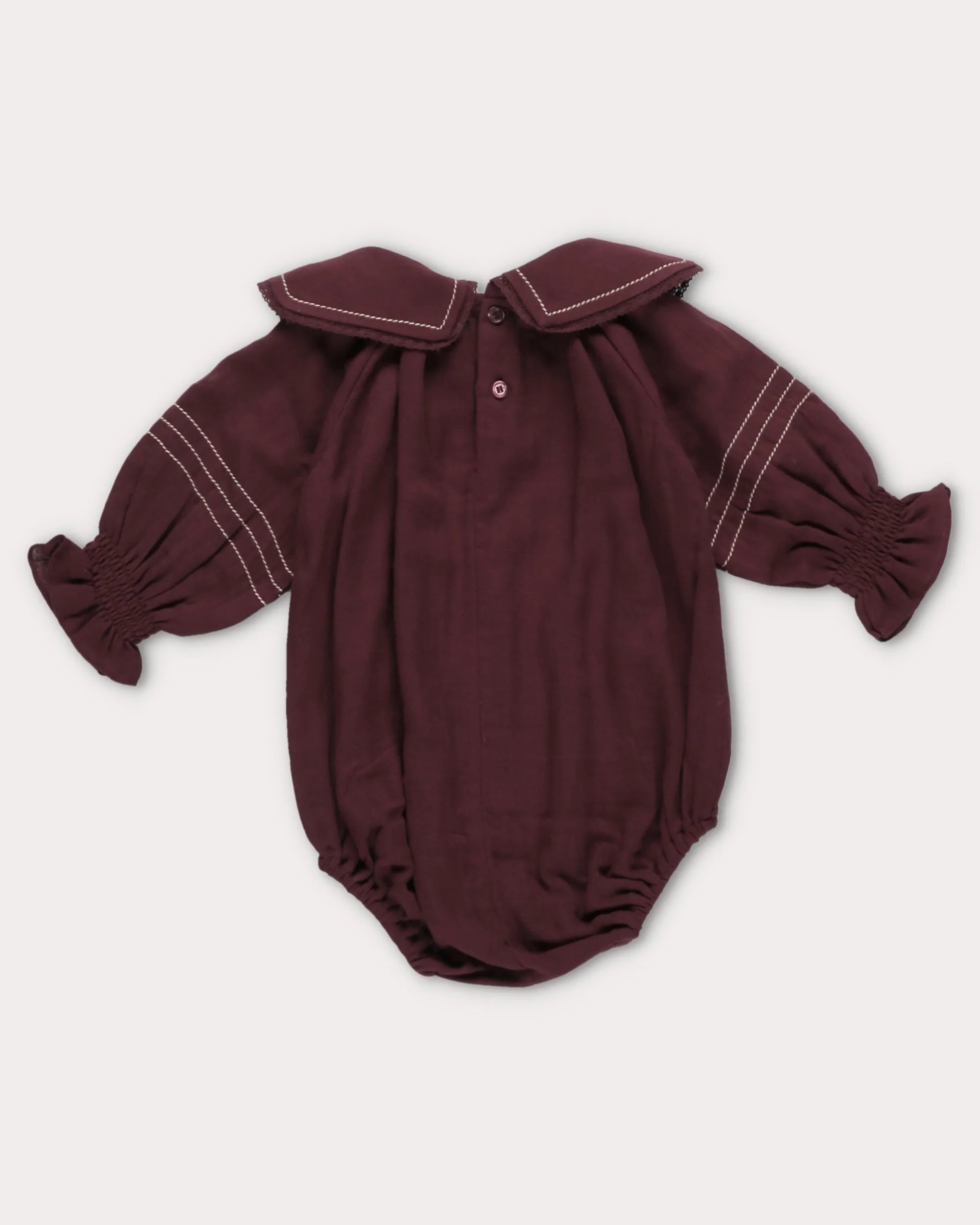Early Sunday, Gladys Baby Bubble Romper in Plum, made from Cotton Double Gauze fabric, featuring a floral embroidered collar with beautiful lace yoke, shown in a back flat-lay view
