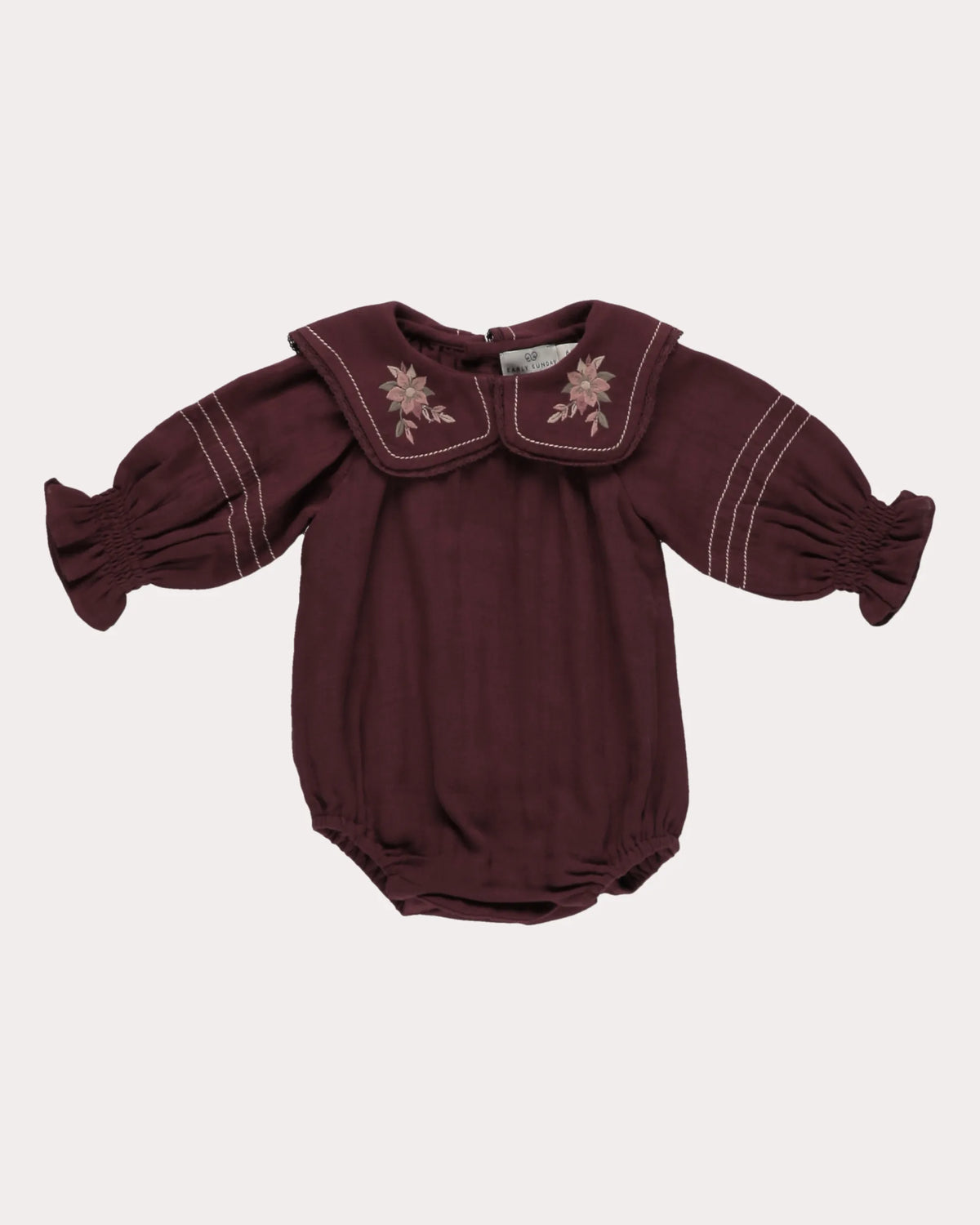 Early Sunday, Gladys Baby Bubble Romper in Plum, made from Cotton Double Gauze fabric, featuring a floral embroidered collar with beautiful lace yoke, shown in a front flat-lay view