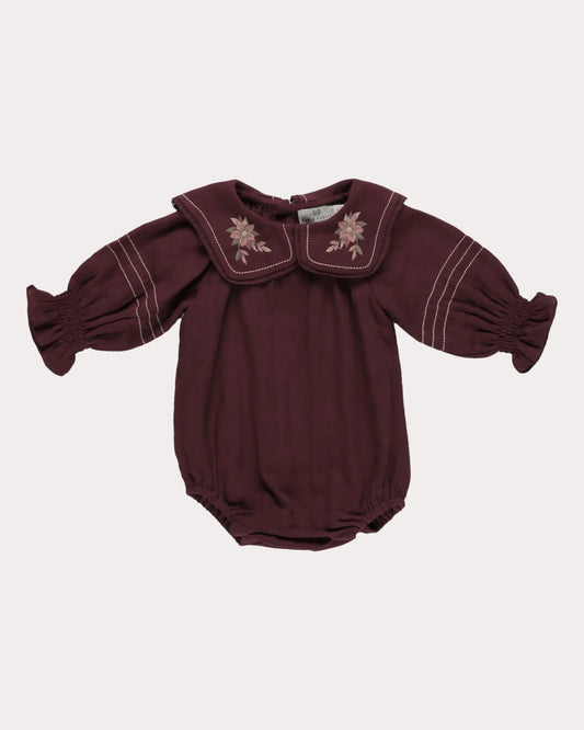 Early Sunday, Gladys Baby Bubble Romper in Plum, made from Cotton Double Gauze fabric, featuring a floral embroidered collar with beautiful lace yoke, shown in a front flat-lay view