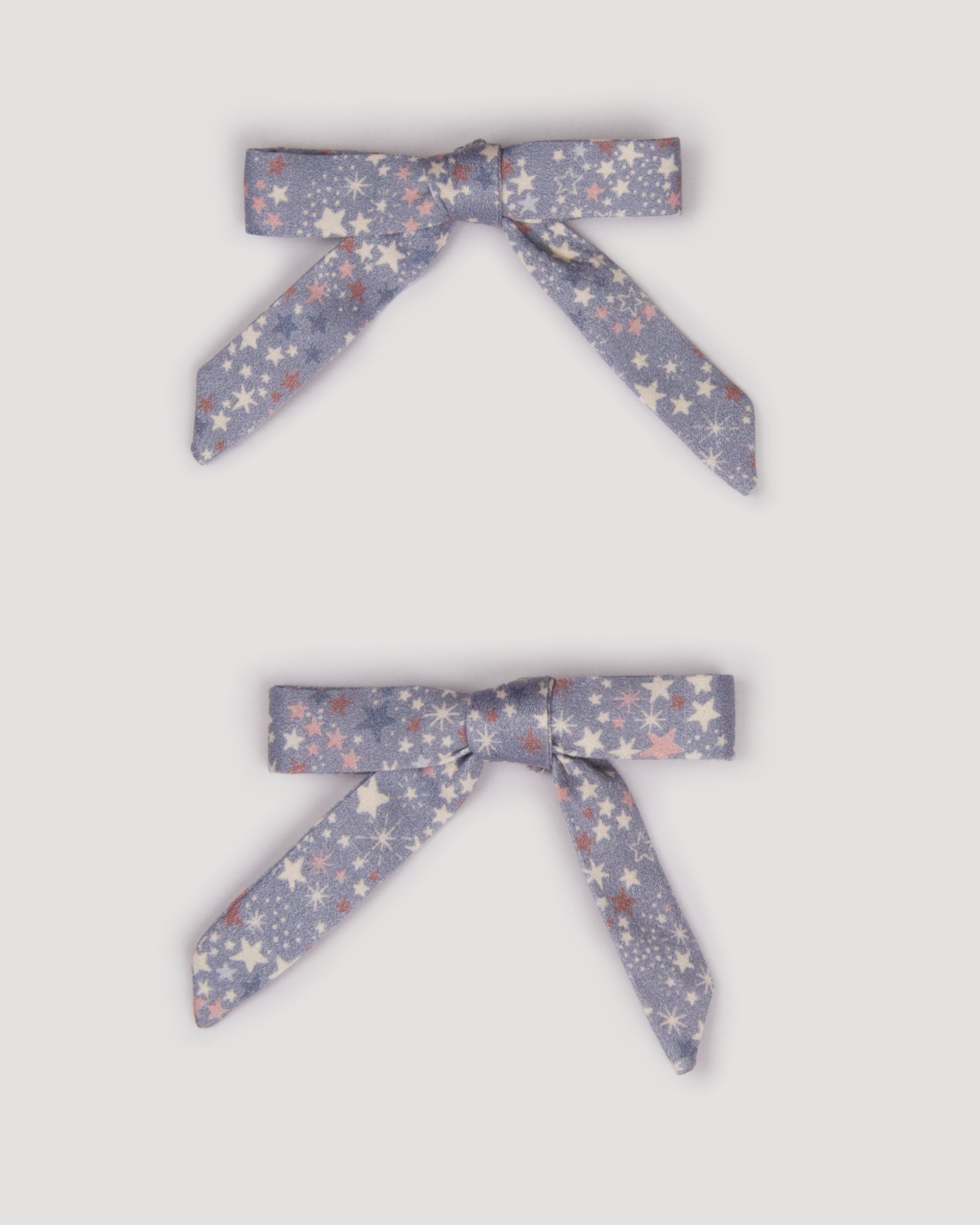 Early Sunday, Grace Clip in Celestial print, made from Printed 60s Cotton Satin fabric, featuring a set of two bow clips with a secure fit, shown in a front flat-lay view