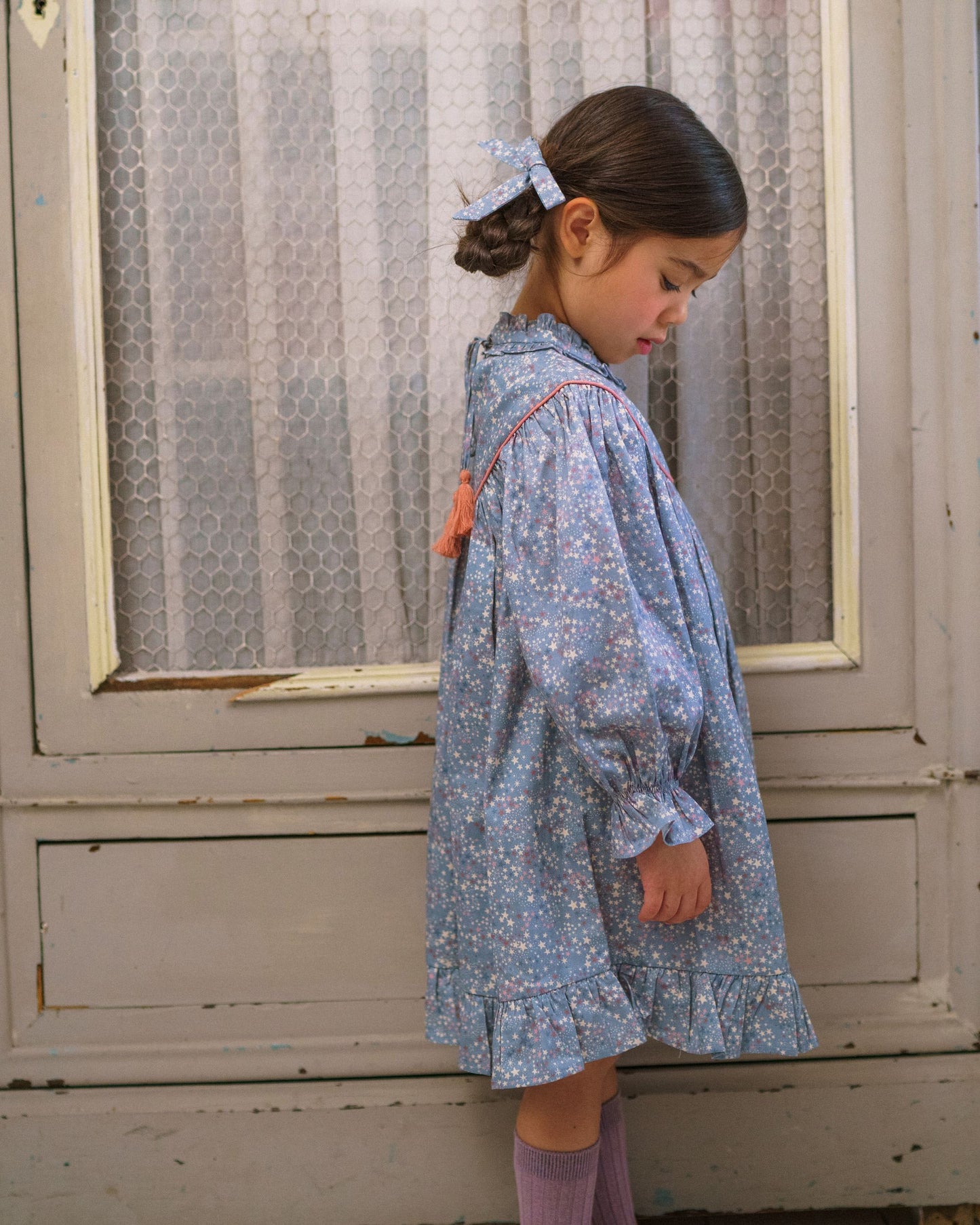 Early Sunday, Grace Clip in Celestial print, made from Printed 60s Cotton Satin fabric, featuring a set of two bow clips with a secure fit, shown in a side view of model wearing it