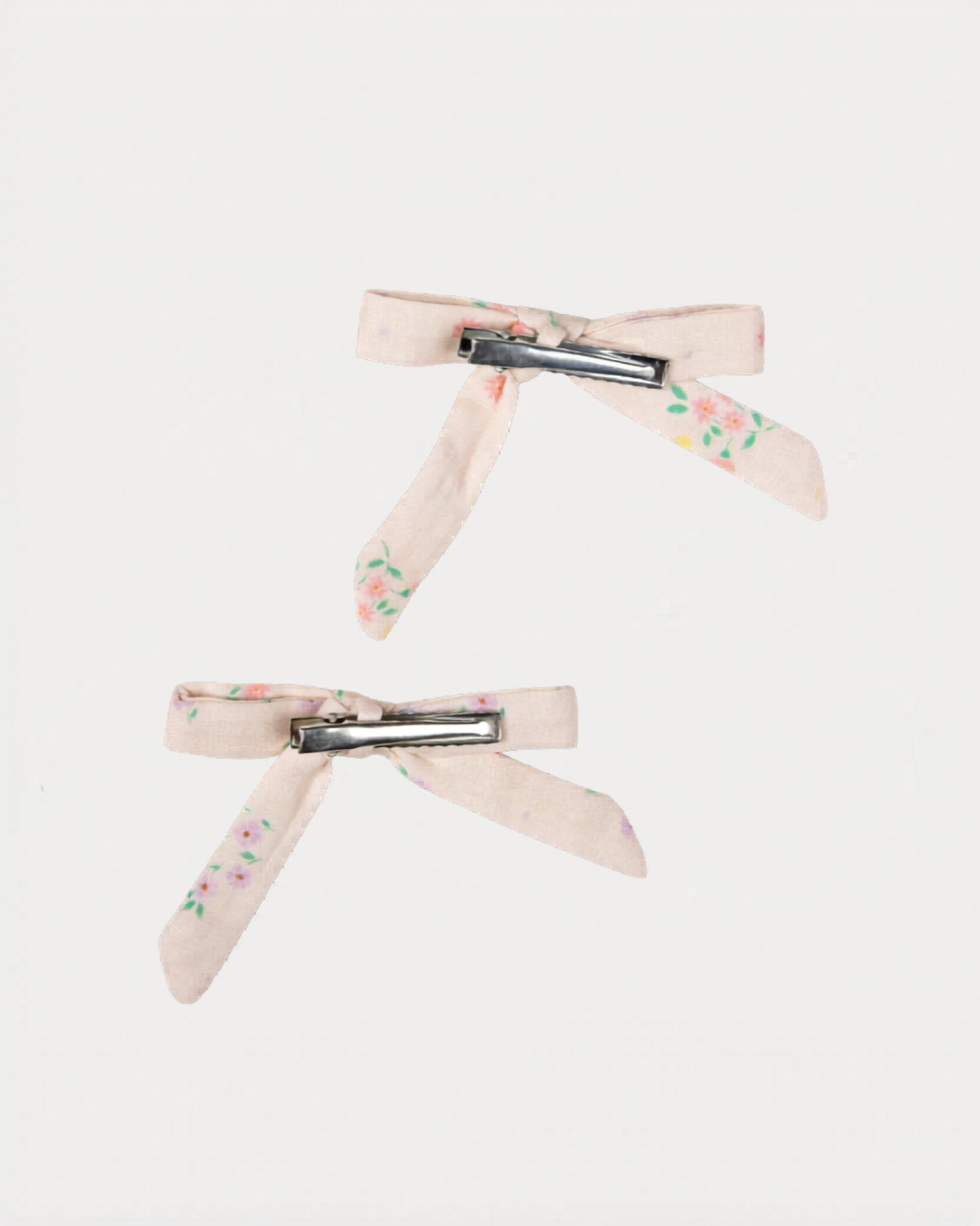 Early Sunday, Grace Clip in Painted Bouquet print, made from Printed 70% Cotton, 30% Linen fabric, featuring a set of two bow clips with a secure fit, shown in a back flat-lay view