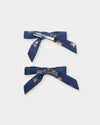 Early Sunday, Grace Clip in Ditsy Bouquet Navy Blue, made from Printed Cotton Satin fabric, featuring a set of two bow clips with a secure fit, shown in a back flat-lay view
