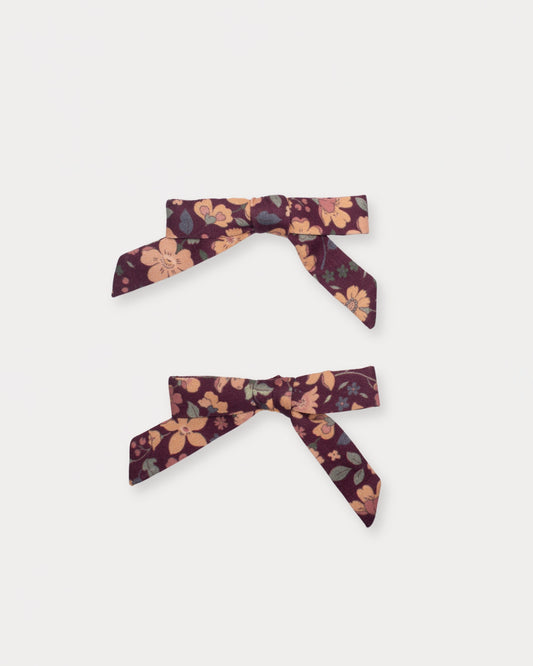 Early Sunday, Grace Clip in Garden Flowers Plum, made from Printed Cotton Satin fabric, featuring a set of two bow clips with a secure fit, shown in a front flat-lay view