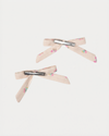Early Sunday, Grace Clip in Butterflies print, made from Printed Cotton Tiny Swiss Dobby fabric, featuring a set of two bow clips with a secure fit, shown in a back flat-lay view