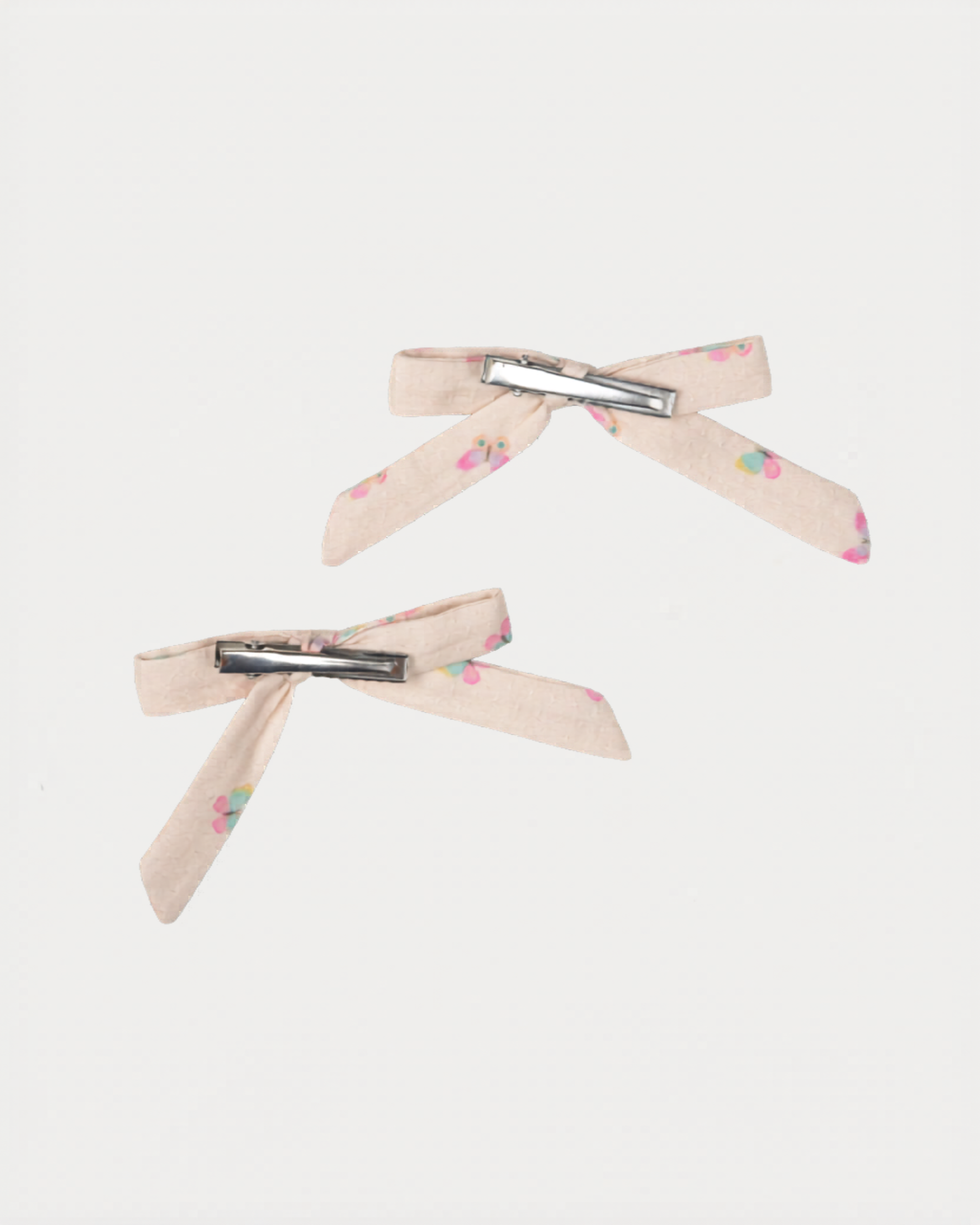 Early Sunday, Grace Clip in Butterflies print, made from Printed Cotton Tiny Swiss Dobby fabric, featuring a set of two bow clips with a secure fit, shown in a back flat-lay view