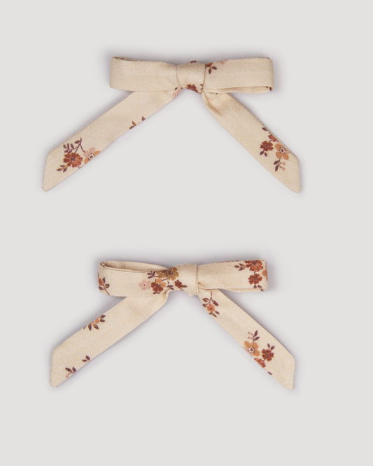 Early Sunday, Grace Clip in Ditsy Bouquet Cream print, made from Printed Viscose Twill fabric, featuring a set of two bow clips with a secure fit, shown in a front flat-lay view
