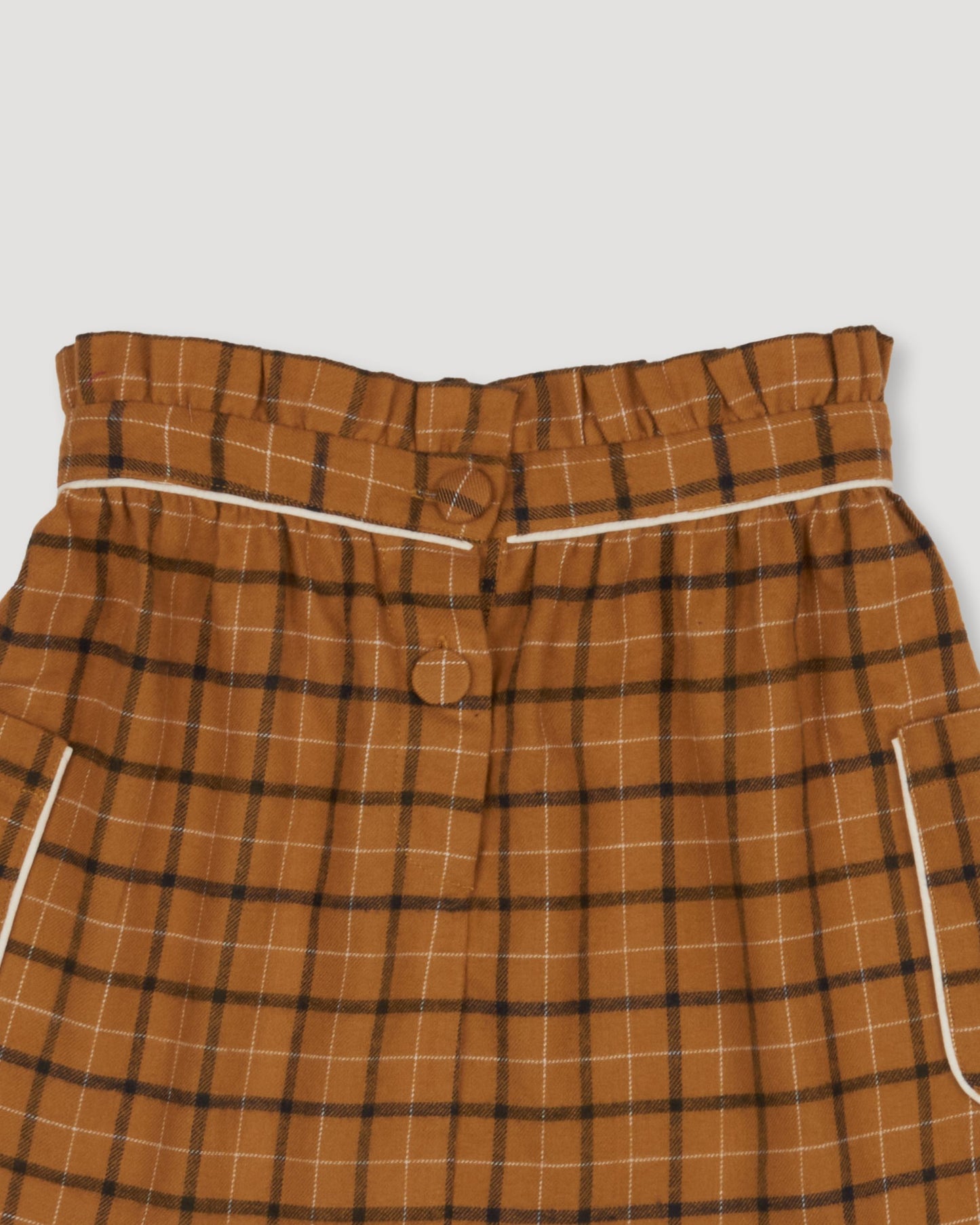 Early Sunday, Hilda Skirt in Almond Checks, made from Cotton Yarn Dyed Brushed Checks fabric, featuring A-line shape with a gathered elastic waistband for comfort, shown in a closeup flat-lay view