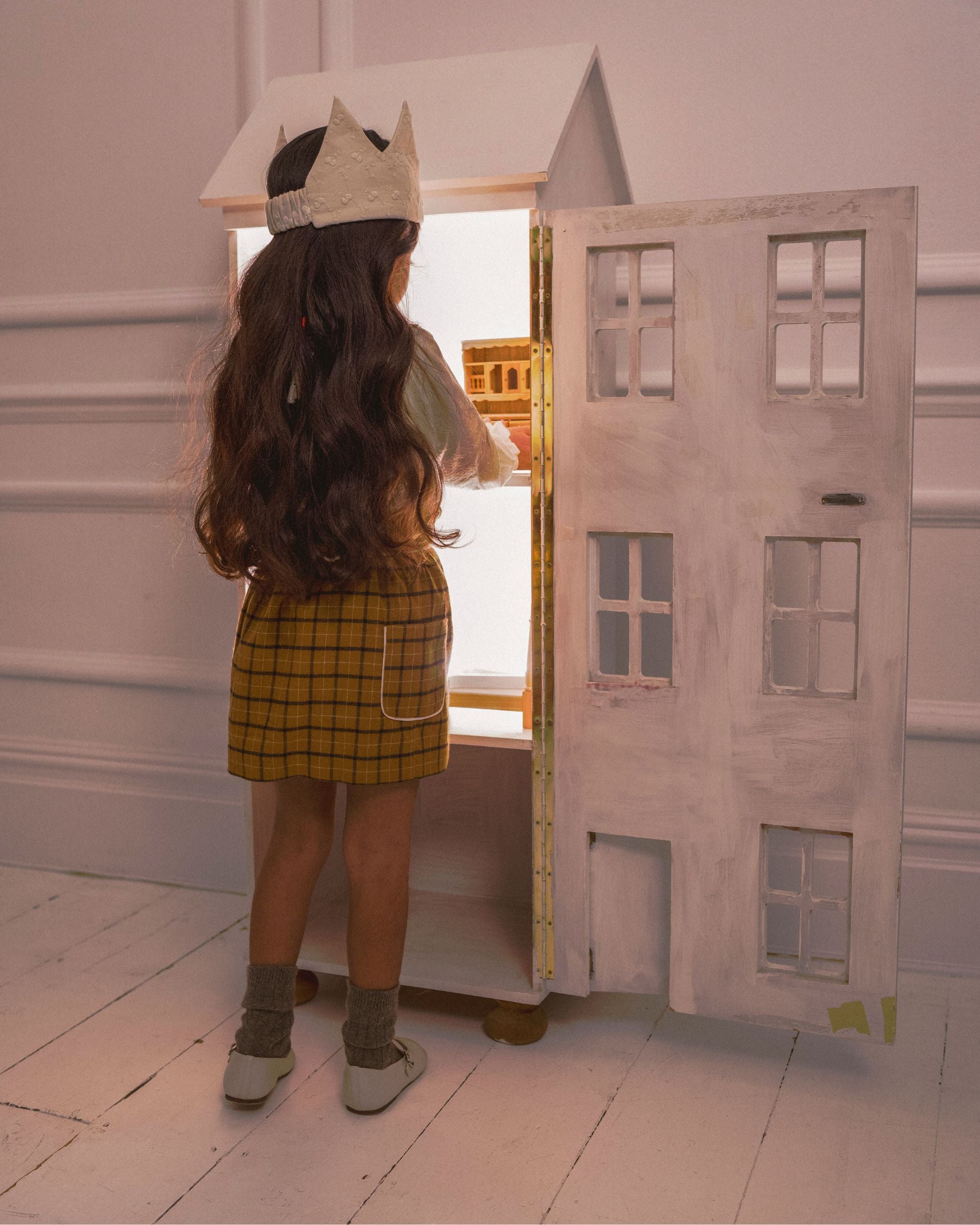 Early Sunday, Hilda Skirt in Almond Checks, made from Cotton Yarn Dyed Brushed Checks fabric, featuring A-line shape with a gathered elastic waistband for comfort, shown in a back view of model wearing it