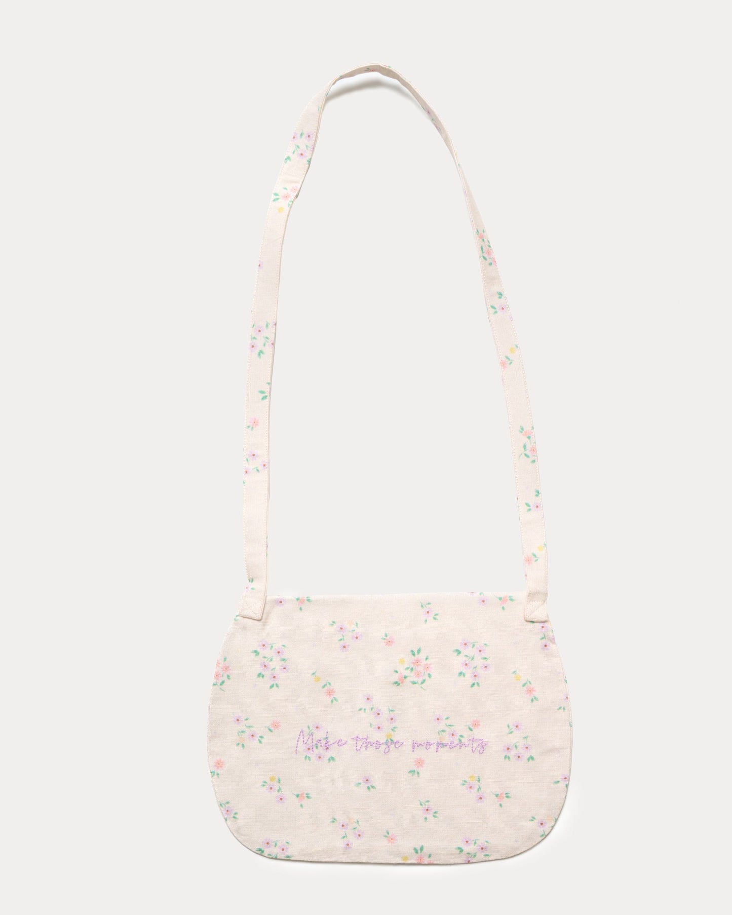 Early Sunday, Hudson Purse in Painted Bouquet print, made from 70% Cotton, 30% Linen fabric, featuring a gathered sling purse design with a flap closure, shown in a back flat-lay view