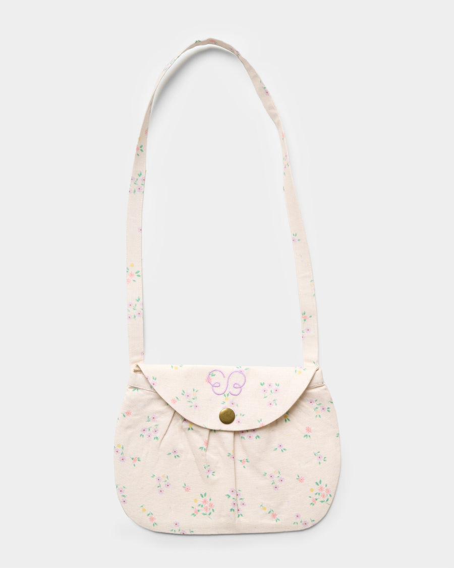 Early Sunday, Hudson Purse in Painted Bouquet print, made from 70% Cotton, 30% Linen fabric, featuring a gathered sling purse design with a flap closure, shown in a front flat-lay view