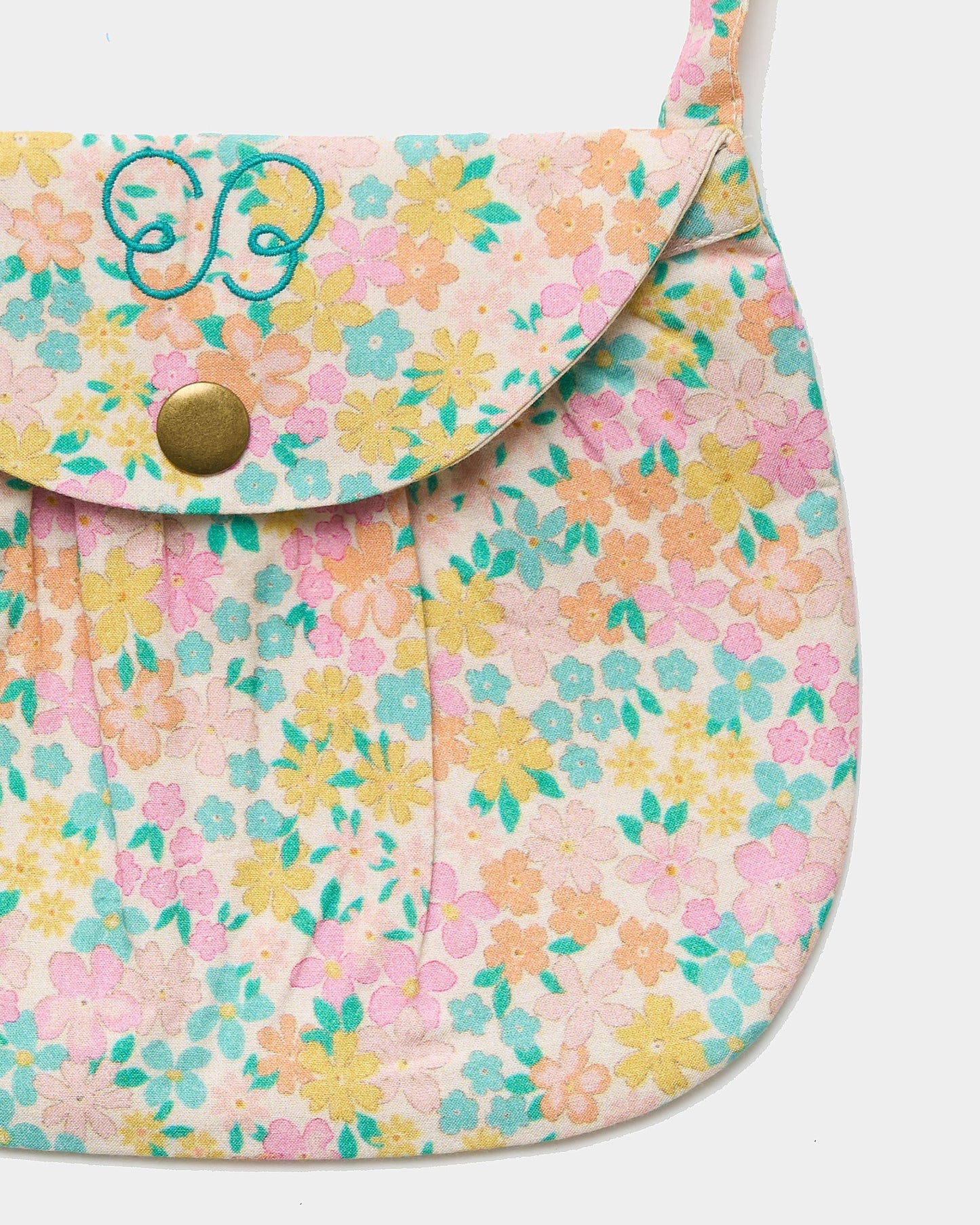 Early Sunday, Hudson Purse in Emma Floral Mint color, made from Organic Printed Cotton Cambric fabric, featuring a gathered sling purse design with a flap closure, shown in closeup flat-lay view