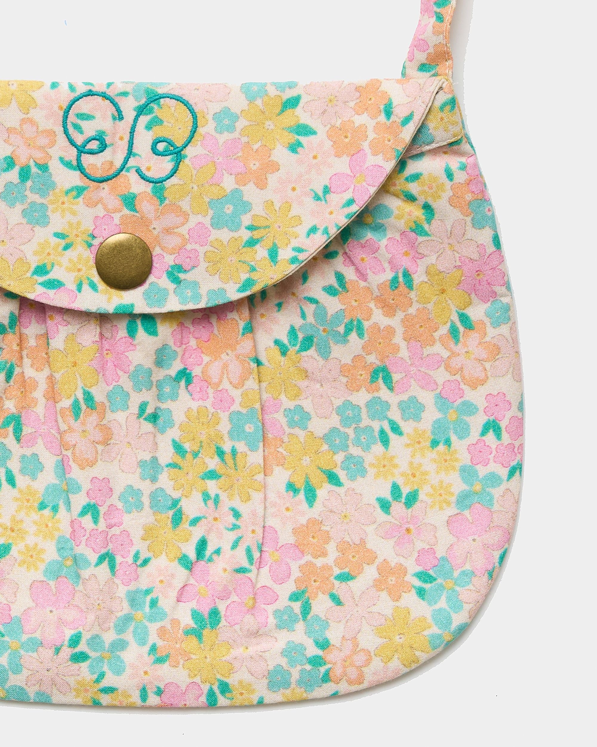 Early Sunday, Hudson Purse in Emma Floral Mint color, made from Organic Printed Cotton Cambric fabric, featuring a gathered sling purse design with a flap closure, shown in closeup flat-lay view