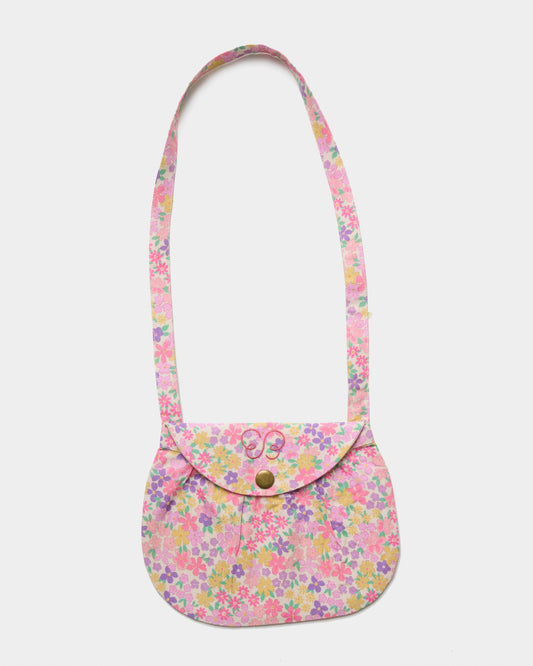 Early Sunday, Hudson Purse in Emma Floral Purple color, made from Organic Printed Cotton Cambric fabric, featuring a gathered sling purse design with a flap closure, shown in front flat-lay view