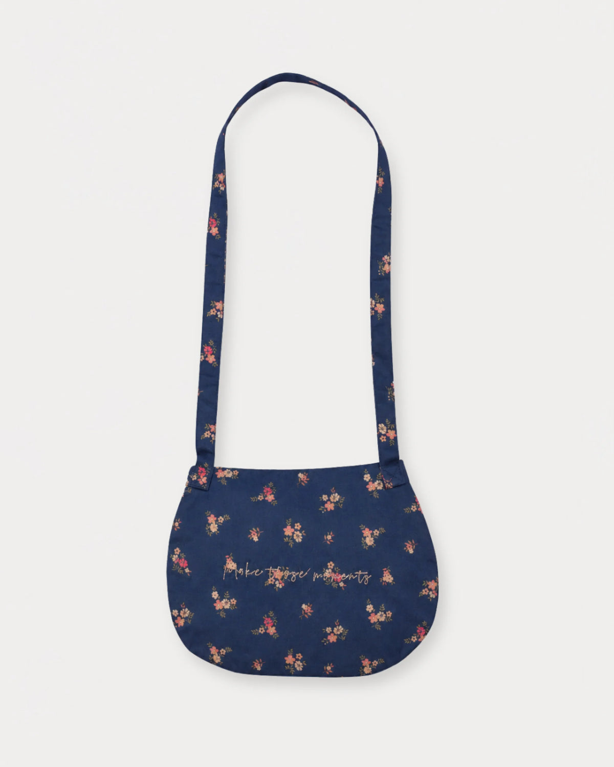 Early Sunday, Hudson Purse in Ditsy Bouquet Navy Blue, made from Printed Cotton Satin fabric, featuring a gathered sling purse design with a flap closure, shown in a back flat-lay view