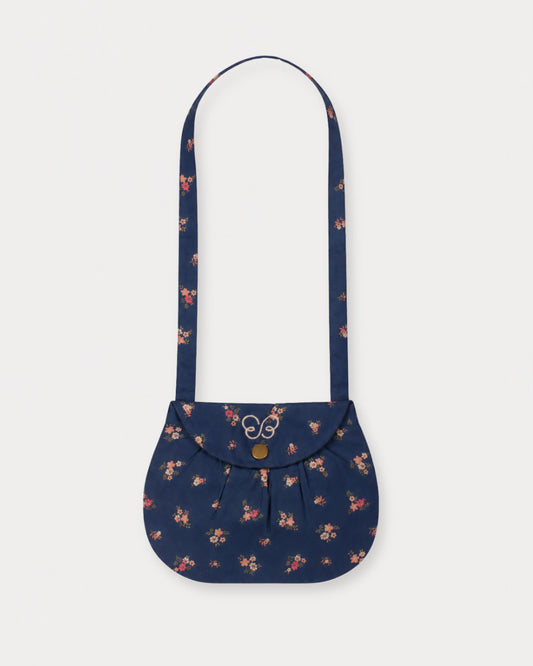 Early Sunday, Hudson Purse in Ditsy Bouquet Navy Blue, made from Printed Cotton Satin fabric, featuring a gathered sling purse design with a flap closure, shown in a front flat-lay view