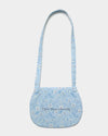 Early Sunday, Hudson Purse in Tonal Floral Blue color, made from Printed Cotton Tiny Swiss Dobby fabric, featuring a gathered sling purse design with a flap closure, shown in back flat-lay view