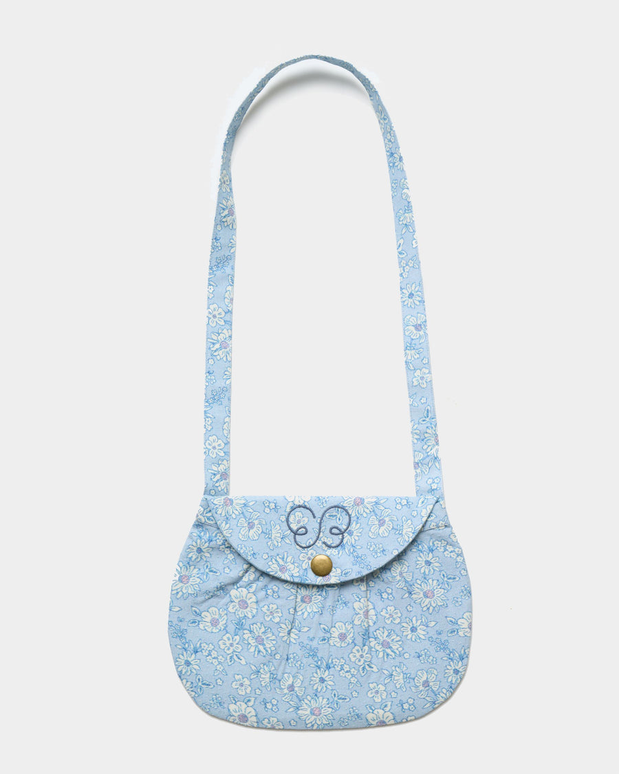 Early Sunday, Hudson Purse in Tonal Floral Blue color, made from Printed Cotton Tiny Swiss Dobby fabric, featuring a gathered sling purse design with a flap closure, shown in front flat-lay view