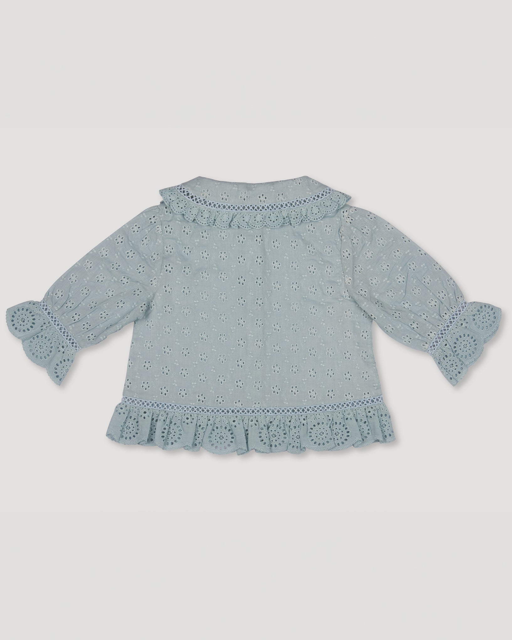 Early Sunday, Iris Blouse in Sea Dream color, made from All-Over Eyelet Embroidered Cotton Schifflie fabric, featuring relaxed fit with delicate detailing for a timeless and feminine look, shown in a back flat-lay view