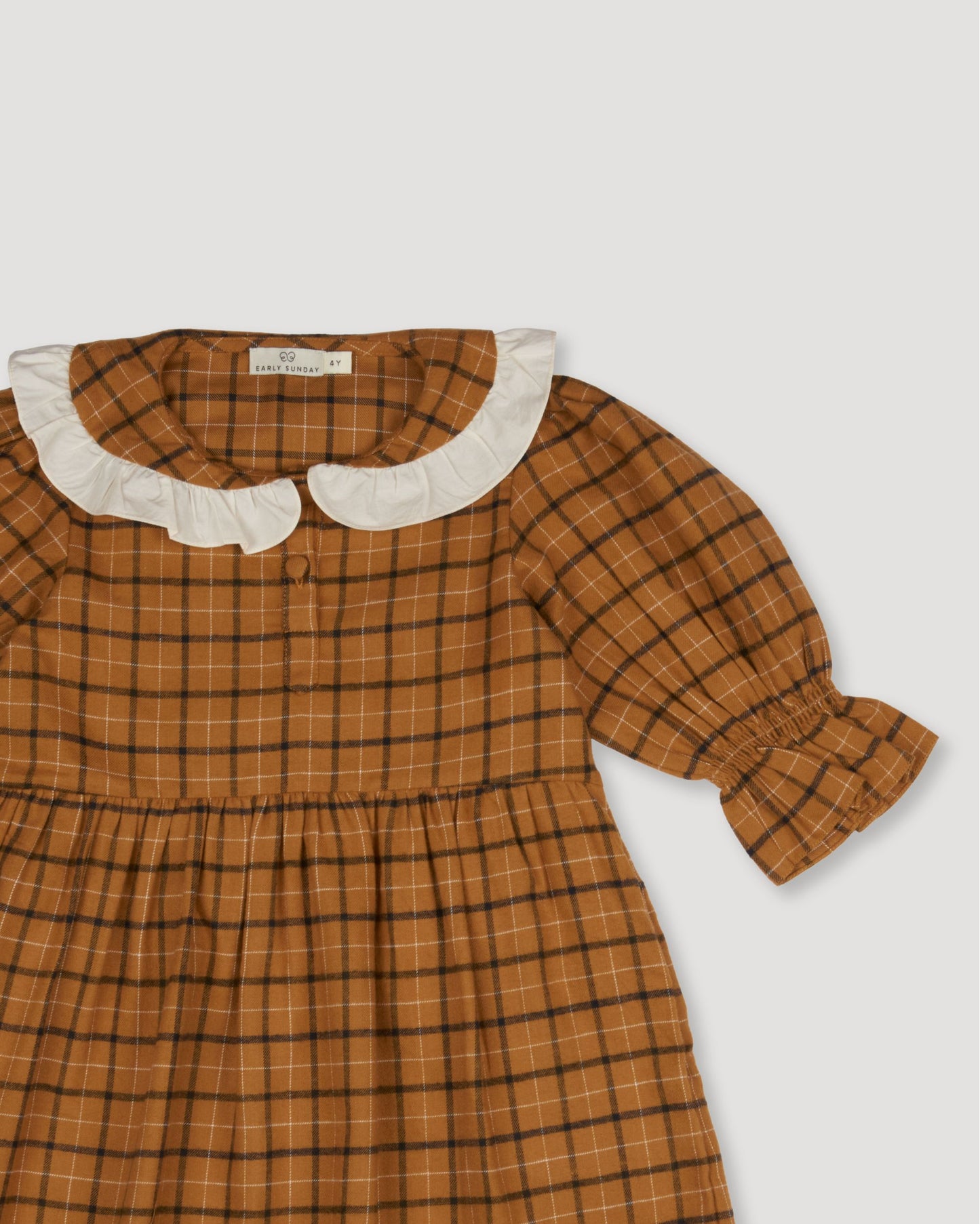 Early Sunday, Jacky Dress in Almond Checks, made from Cotton Yarn Dyed Brushed Checks fabric, featuring White contrast scallop-edge collar adds a sweet vintage touch, shown in a closeup flat-lay view