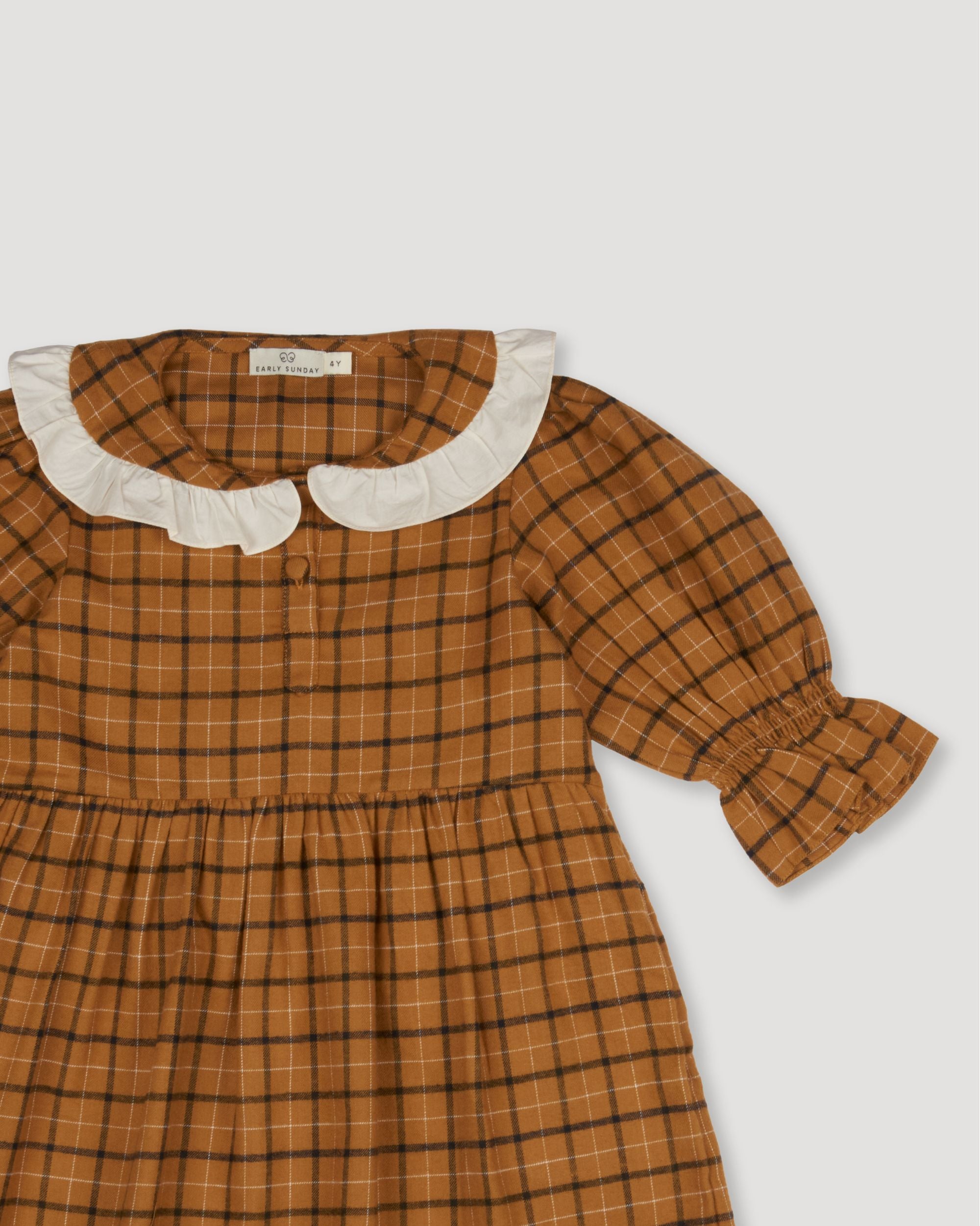 Early Sunday, Jacky Dress in Almond Checks, made from Cotton Yarn Dyed Brushed Checks fabric, featuring White contrast scallop-edge collar adds a sweet vintage touch, shown in a closeup flat-lay view