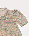 Early Sunday, Jane Dress in Emma Floral Mint color, made from printed 60s cotton cambric fabric, featuring Smocked / embroidered yoke, peter pan collar and puffed short sleeves, shown in a closeup flat-lay view