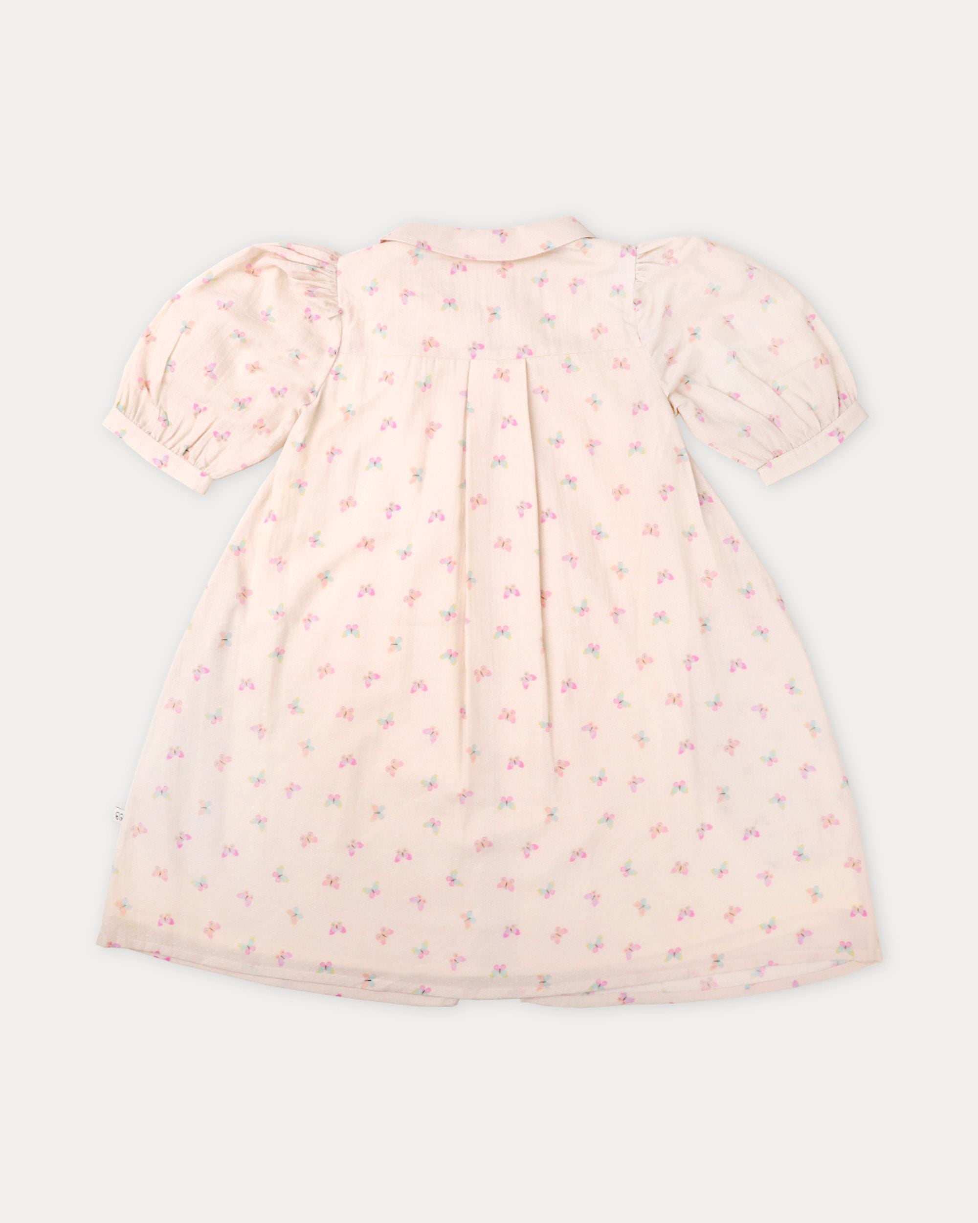 Early Sunday, Jane Dress in Butterfly Print color, made from printed cotton tiny swiss dobby fabric, featuring Smocked / embroidered yoke, peter pan collar and puffed short sleeves, shown in a back flat-lay view