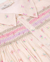 Early Sunday, Jane Dress in Butterfly Print color, made from printed cotton tiny swiss dobby fabric, featuring Smocked / embroidered yoke, peter pan collar and puffed short sleeves, shown in a closeup flat-lay view
