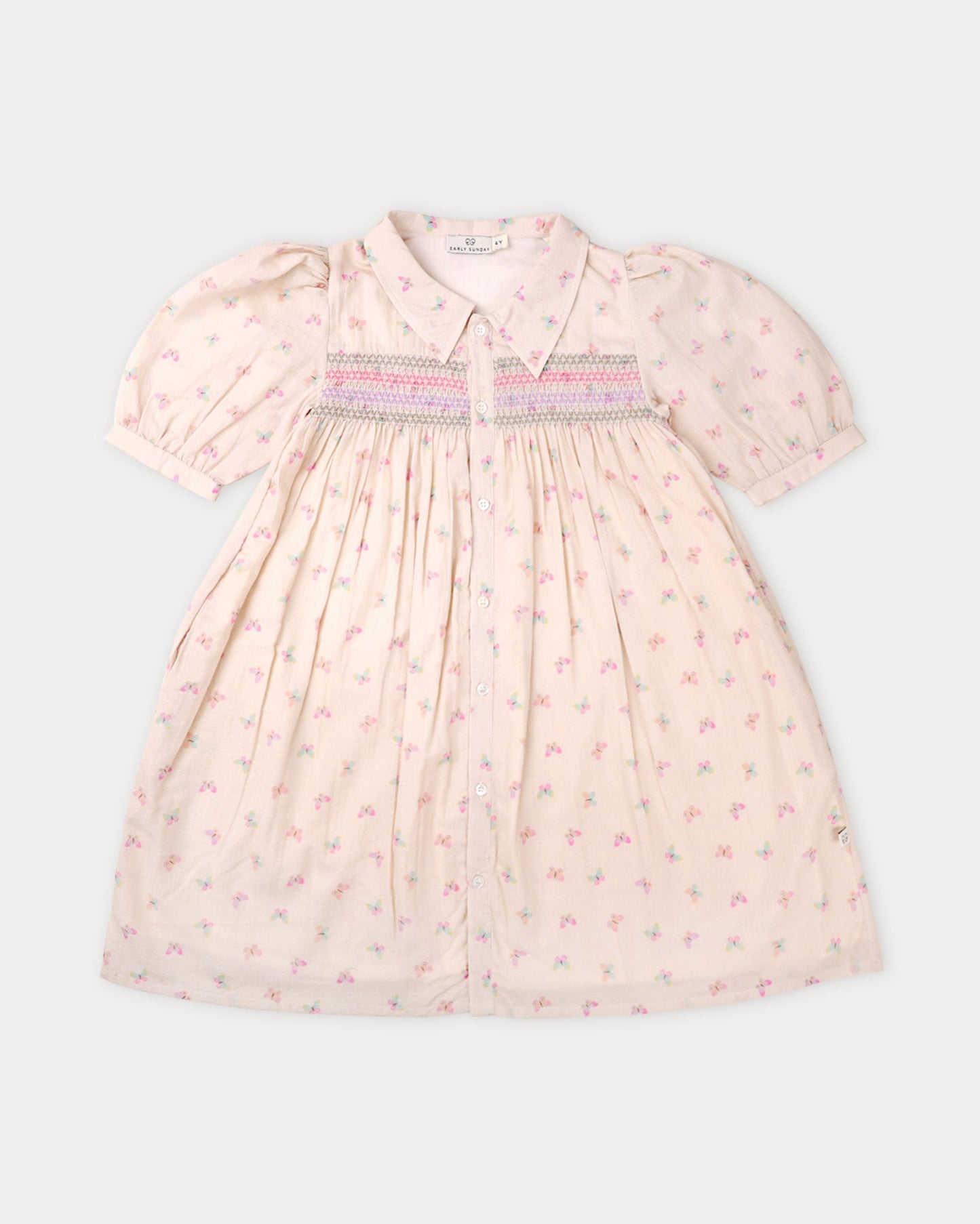 Early Sunday, Jane Dress in Butterfly Print color, made from printed cotton tiny swiss dobby fabric, featuring Smocked / embroidered yoke, peter pan collar and puffed short sleeves, shown in a front flat-lay view