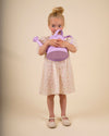 Early Sunday, Jane Dress in Butterfly Print color, made from printed cotton tiny swiss dobby fabric, featuring Smocked / embroidered yoke, peter pan collar and puffed short sleeves, shown in a model standing facing front wearing