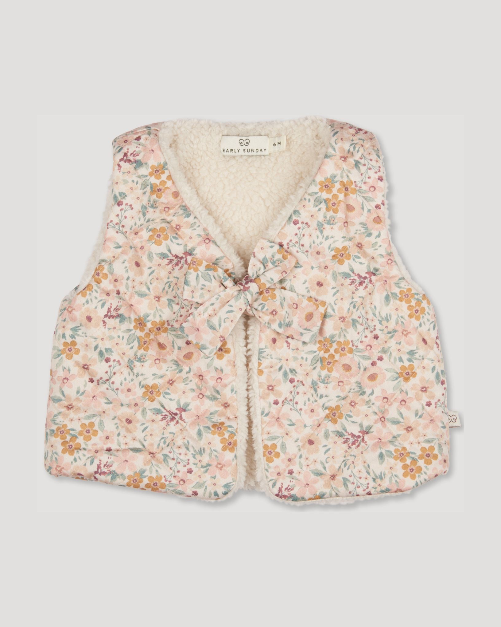 Early Sunday, Jilly Gilet in Floral print, made from Printed 60s Cotton Satin fabric, featuring a sleeveless gilet design with soft padding, shown in a front flat-lay view