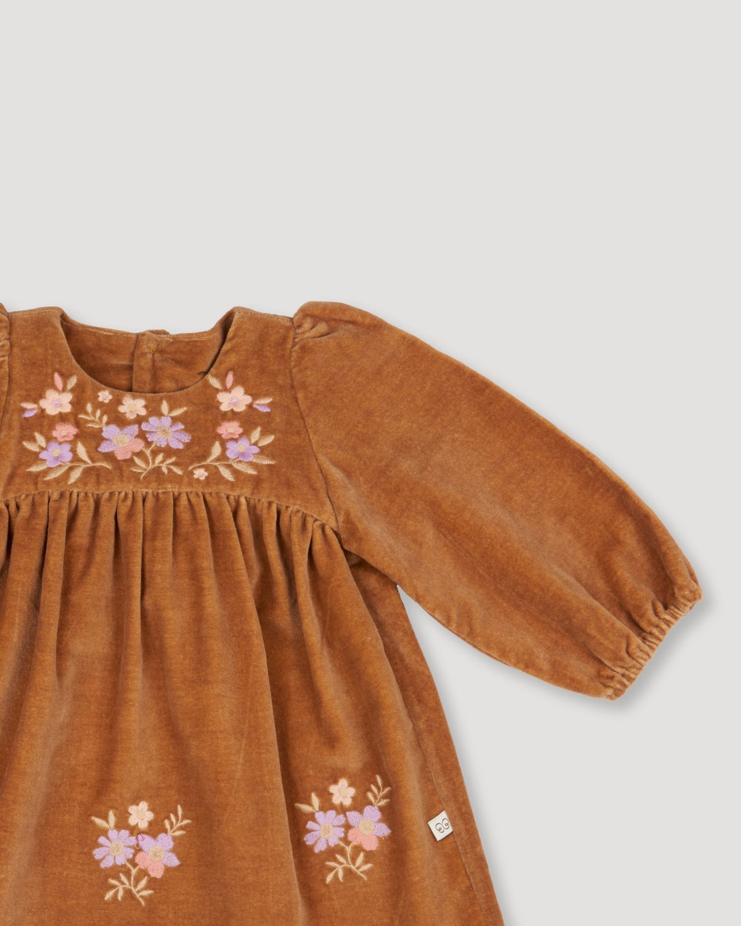 Early Sunday, Joni Baby Dress & Bloomer Set in Almond color, made from Dyed Cotton Velvet fabric, featuring long puff sleeves & gathered waist with matching bloomers, shown in a closeup flat-lay view