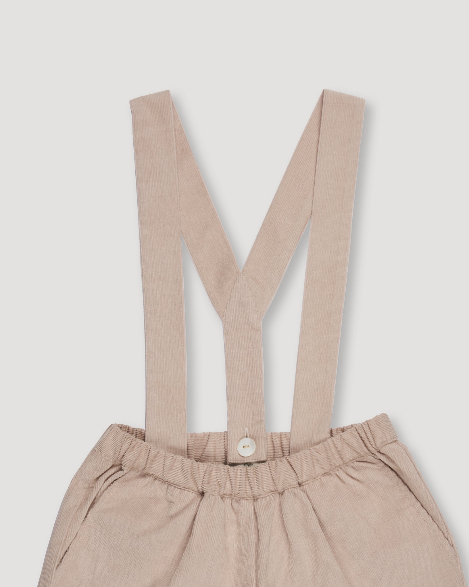 Early Sunday, Joseph Short Dungaree in Beige, made from Cotton Corduroy fabric, featuring short dungaree with adjustable straps, shown in a closeup flat-lay view
