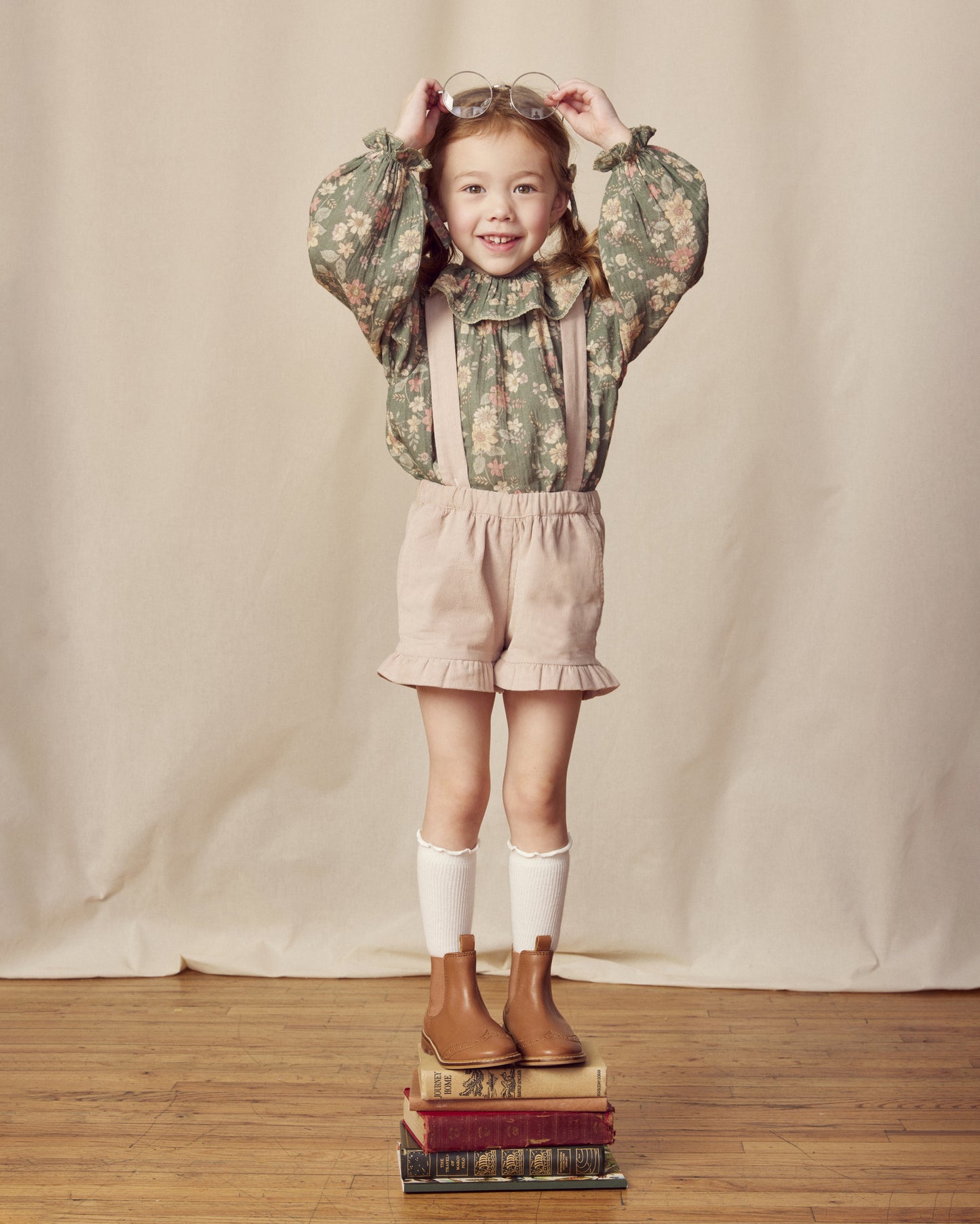 Early Sunday, Joseph Short Dungaree in Beige, made from Cotton Corduroy fabric, featuring short dungaree with adjustable straps, shown in a front view of model wearing it
